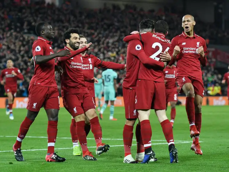 Liverpool players celebrate against Arsenal