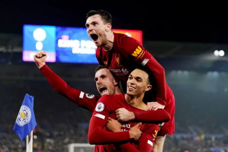 Liverpool star Trent Alexander-Arnold celebrates with Andrew Robertson and Jordan Henderson.