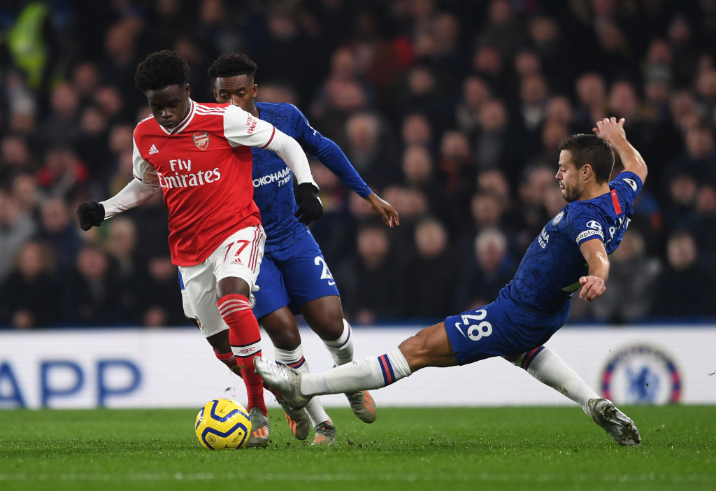 Bukayo Saka of Arsenal takes on Cesar Azpilicueta of Chelsea during a Premier League match. (Photo by David Price/Arsenal FC via Getty Images)