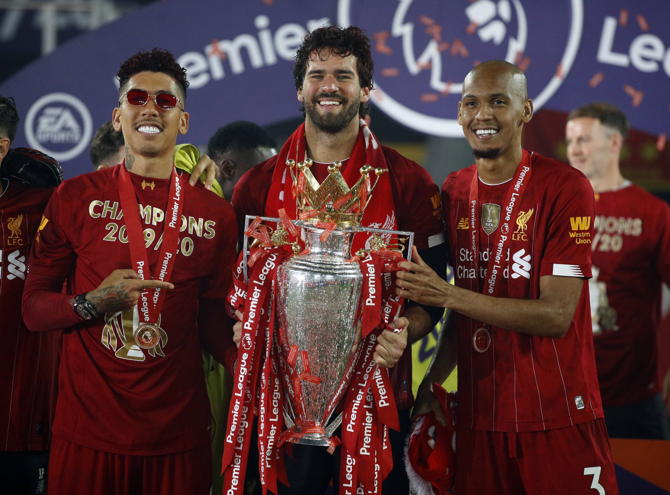 Liverpool v Chelsea – Premier League – Anfield Liverpool s Roberto Firmino, Alisson and Fabinho celebrate with the Premi