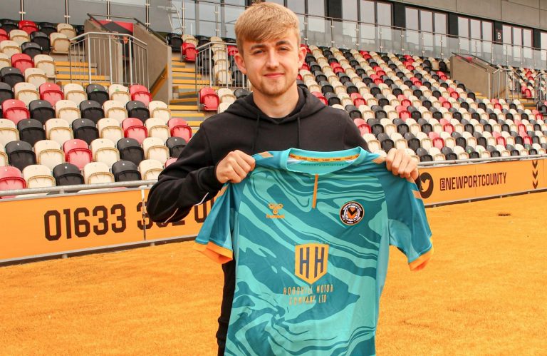 Jake Cain poses with the Newport County jersey.