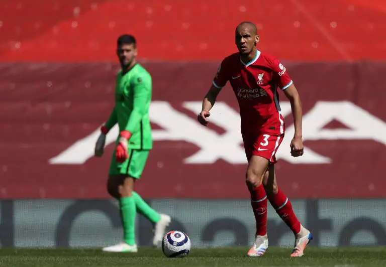 Brazil internationals Fabinho and Alisson Becker in action for Liverpool.