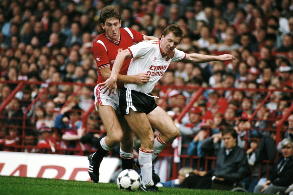 Steve Nicol of Liverpool is challenged by Norman Whiteside of Manchester United. (Photo by Mike King/Allsport/Getty Images)