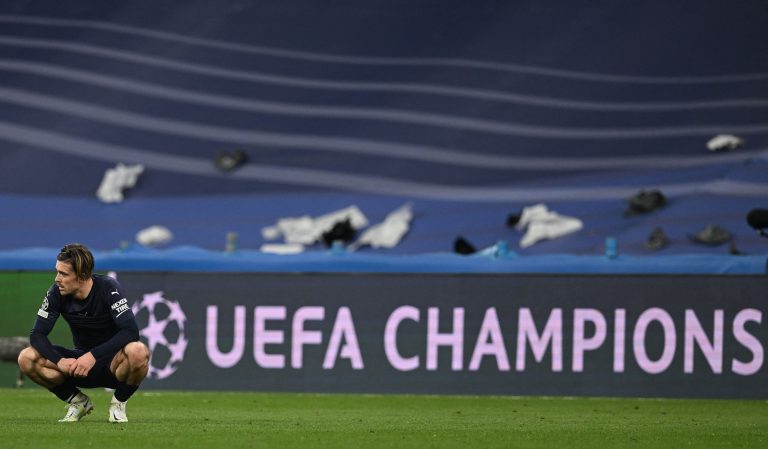 Jack Grealish looks on as Manchester City are dumped out of Europe. (Photo by PAUL ELLIS/AFP via Getty Images)