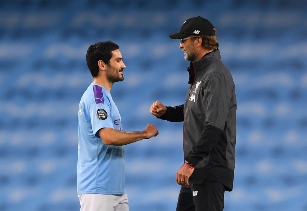 Jurgen Klopp interacts with Ilkay Gundogan of Manchester City. (Photo by Laurence Griffiths/Getty Images)