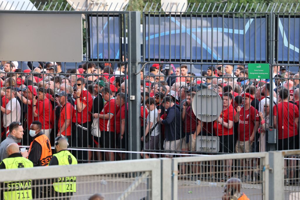 Liverpool fans stand outside unable to get in in time leading to the match being delayed at Parc des Princes. (Photo by THOMAS COEX/AFP via Getty Images)