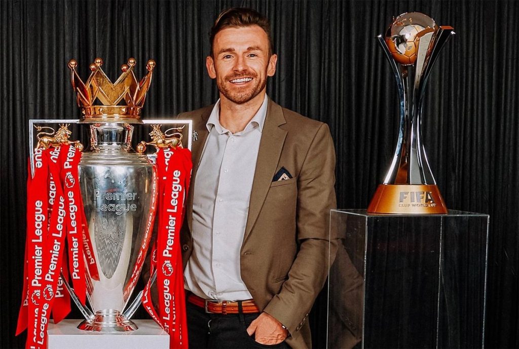 Julian Ward with Liverpool's Premier League and FIFA Club World Cup trophies.