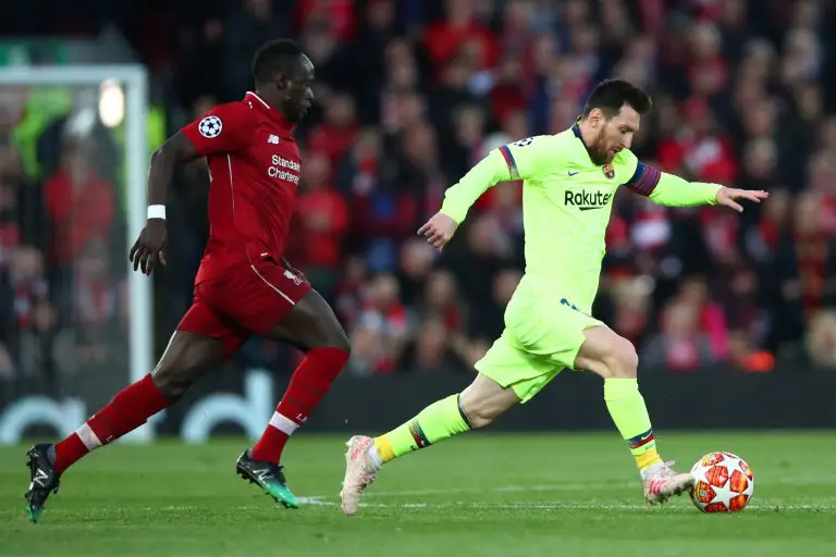 Lionel Messi of Barcelona in action against Liverpool Sadio Mane.