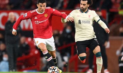 Cristiano Ronaldo of Manchester United holds off Mohamed Salah of Liverpool.