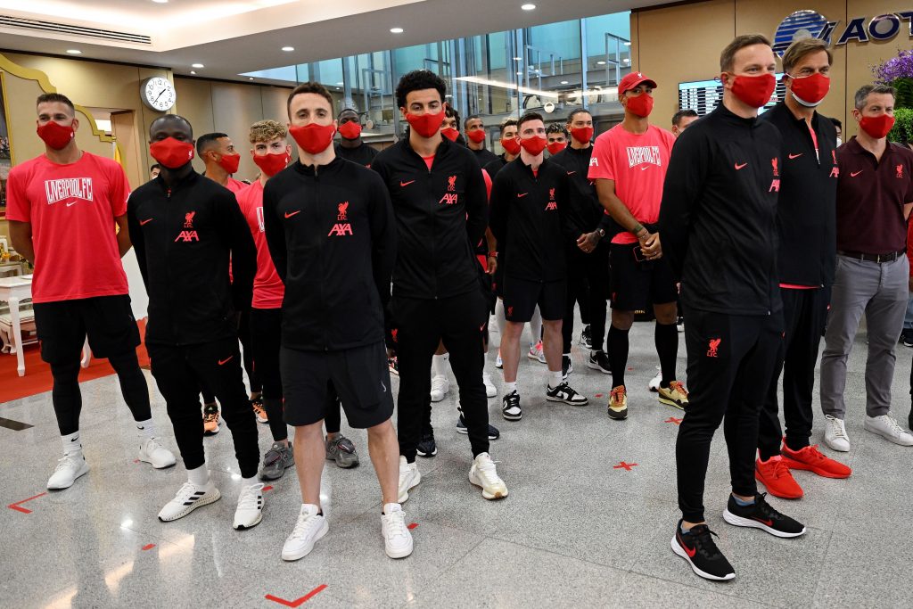 Liverpool FC manager Jurgen Klopp (2nd R) poses with his team upon arrival at Suvarnabhumi International Airport. (