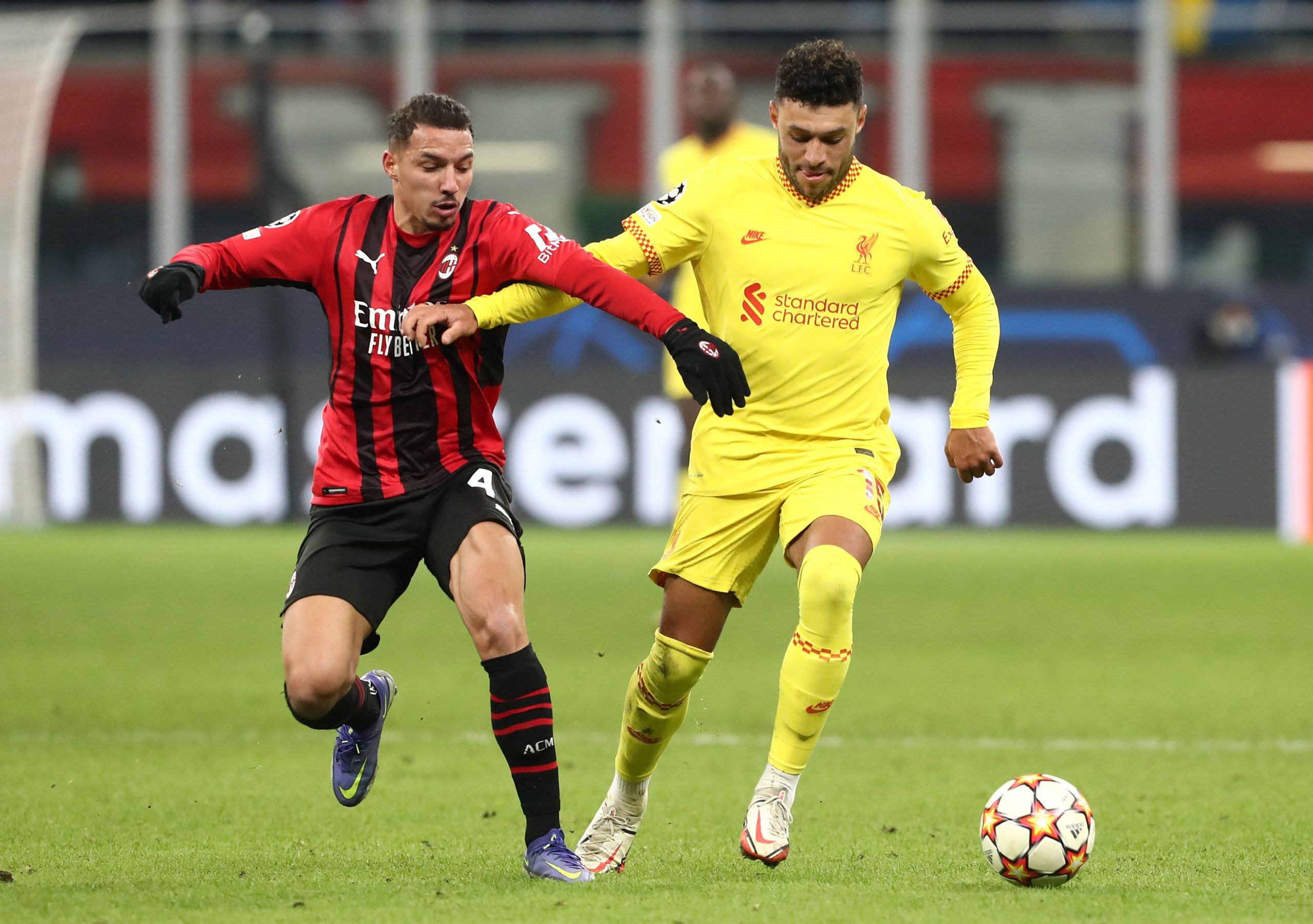 Alex Oxlade-Chamberlain of Liverpool is challenged by Ismael Bennacer of AC Milan.