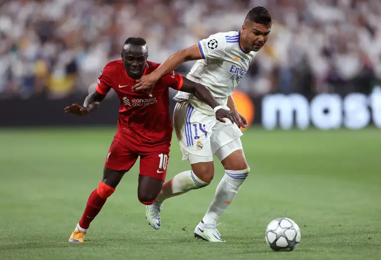 Sadio Mane of Liverpool is challenged by Casemiro of Real Madrid.