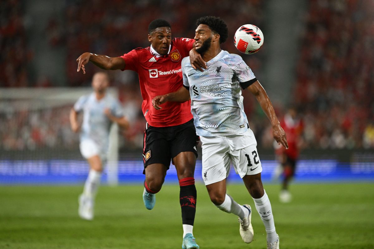 Anthony Martial views for the ball with Liverpool's Joe Gomez.