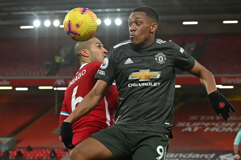 Thiago Alcantara (L) vies with Manchester United's Anthony Martial.