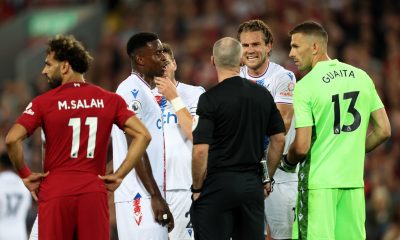 Joachim Andersen of Crystal Palace speaks with the referee after a challenge which resulted in a red card for Darwin Nunez as Mohamed Salah watches on.