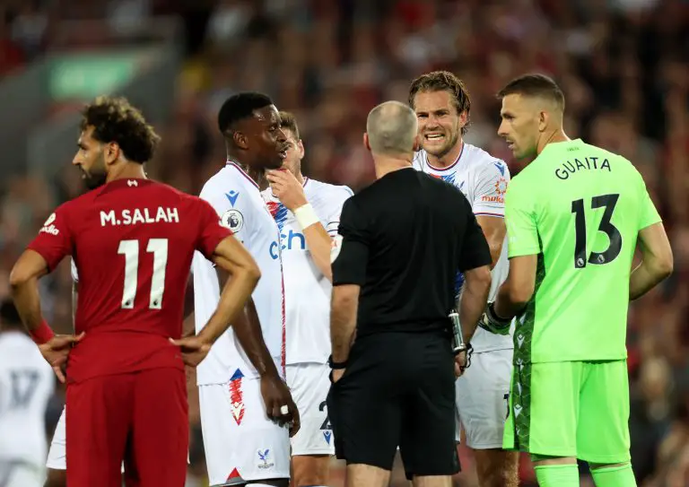 Joachim Andersen of Crystal Palace speaks with the referee after a challenge which resulted in a red card for Darwin Nunez as Mohamed Salah watches on.