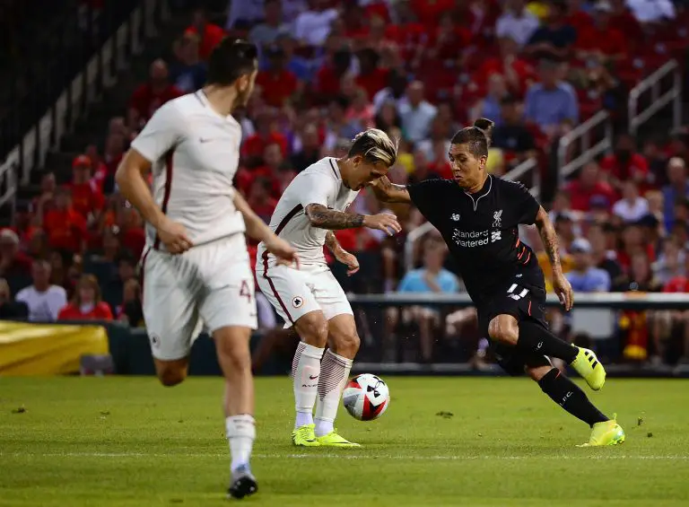 Roberto Firmino vies for the ball with AS Roma's Leandro Paredes. (Photo by Jeff Curry/Getty Images)