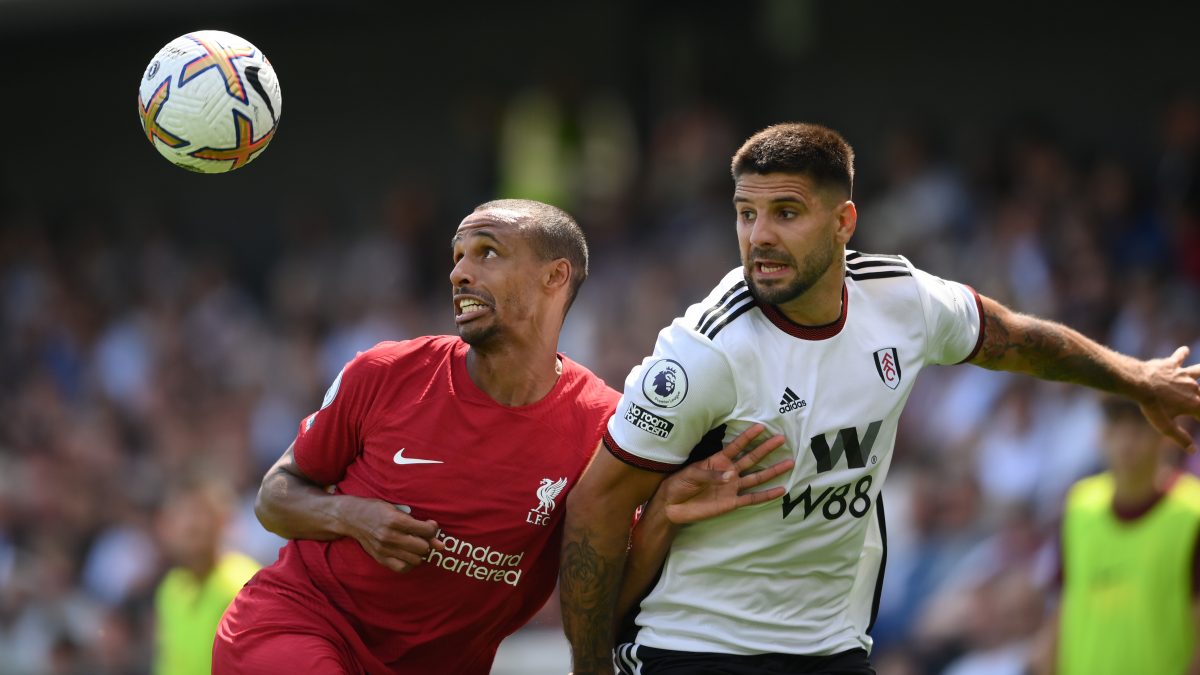 Joel Matip of Liverpool is challenged by Aleksandar Mitrovic of Fulham. (Photo by Mike Hewitt/Getty Images)