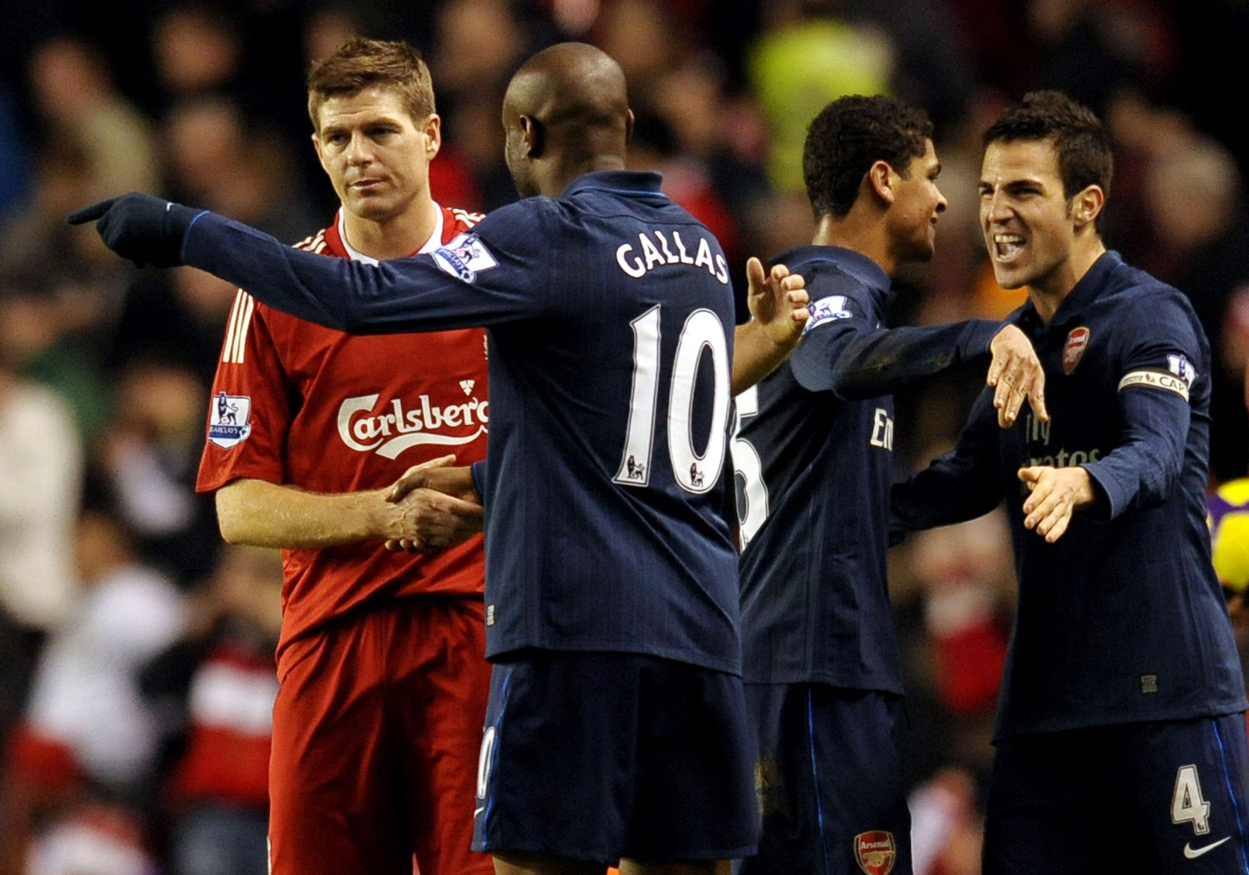 Steven Gerrard (L) shakes hands with William Gallas