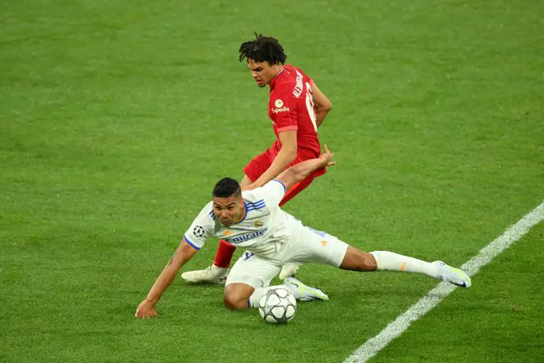 Trent Alexander-Arnold of Liverpool battles for possession with Casemiro of Real Madrid. (Photo by Matthias Hangst/Getty Images)