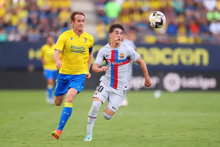 Gavi of FC Barcelona battles for possession with Alex Fernandez of Cadiz CF.