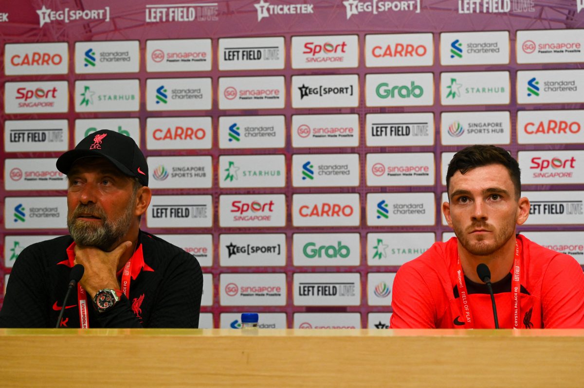 Andy Robertson and Jurgen Klopp at a press conference for Liverpool in Singapore. (Photo by ROSLAN RAHMAN/AFP via Getty Images)