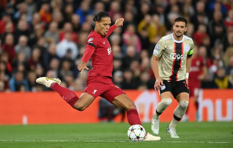 Virgil van Dijk kicks the ball as Ajax's Dusan Tadic watches on.