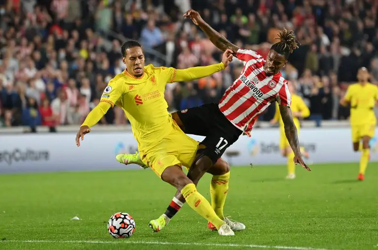 Virgil van Dijk of Liverpool tackles Brentford's Ivan Toney.