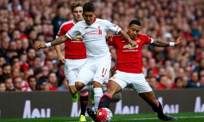 Memphis Depay of Manchester United contests for the ball with Liverpool's Roberto Firmino.