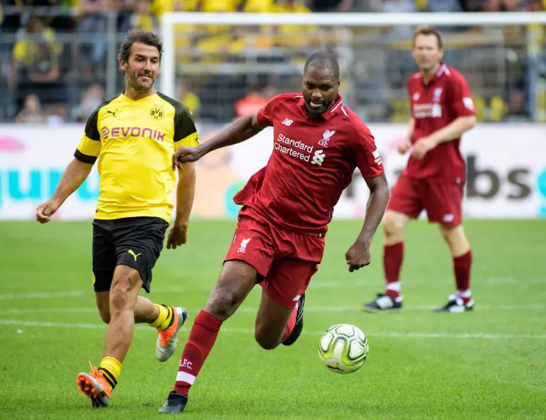 Liverpool's Salif Diao plays against Karl-Heinz Riedle during the friendly legends game in August 2018.