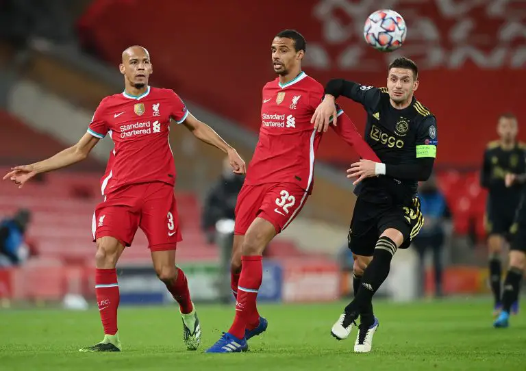 Dusan Tadic of Ajax battles for possession with Fabinho and Joel Matip of Liverpool. (Photo by Michael Regan/Getty Images)