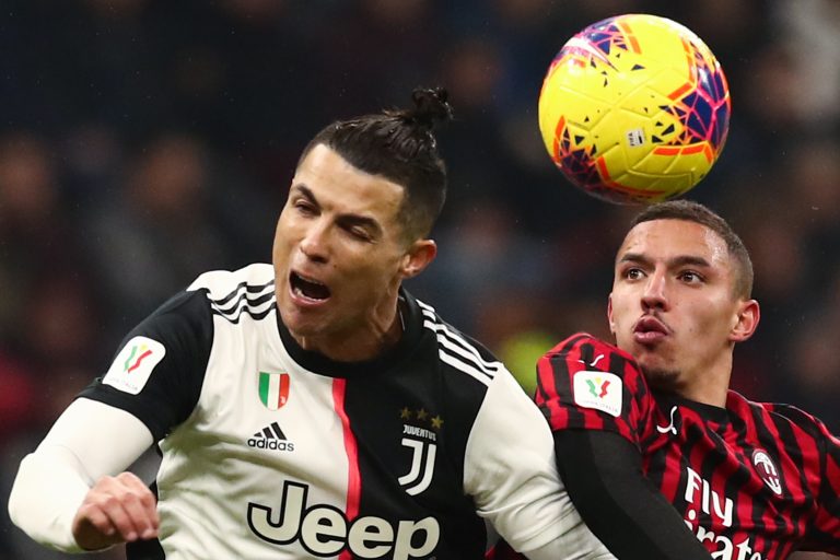 Cristiano Ronaldo and AC Milan's Ismael Bennacer vie for the ball.
