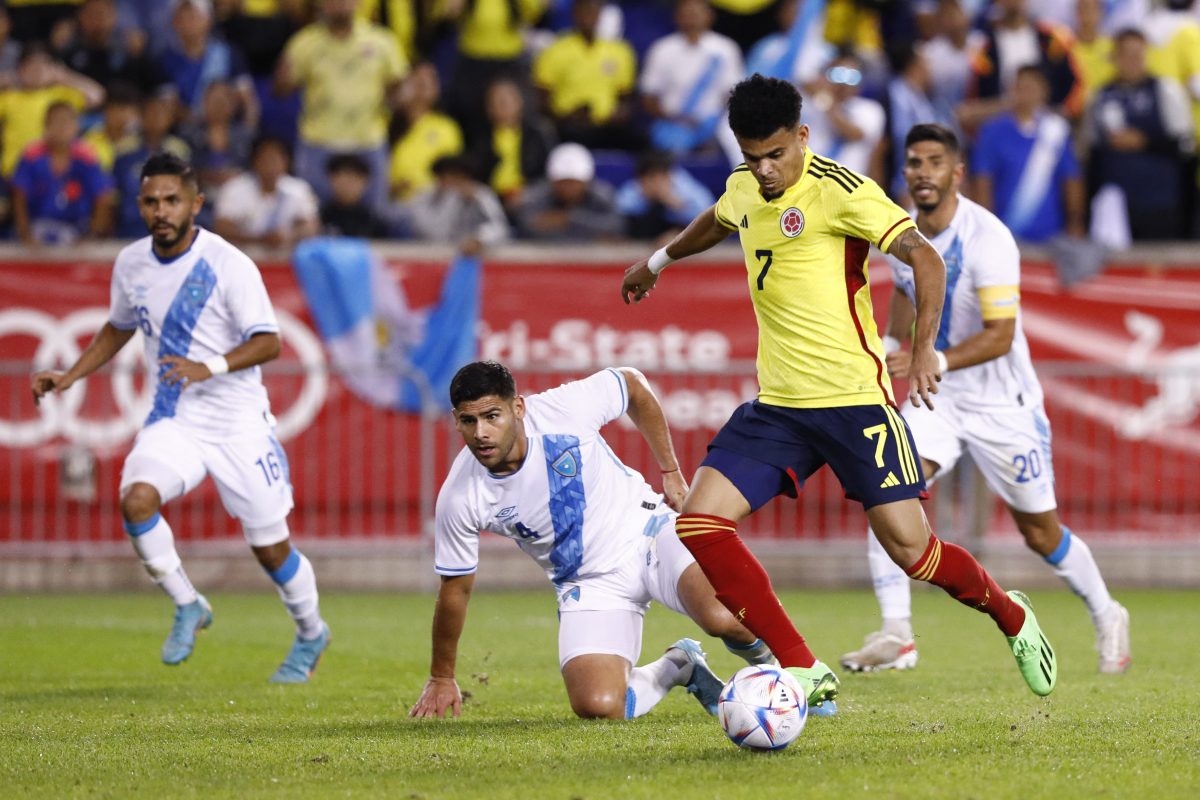 Liverpool's Luis Diaz shoots in between players during the international friendly football match between Colombia and Guatemala.