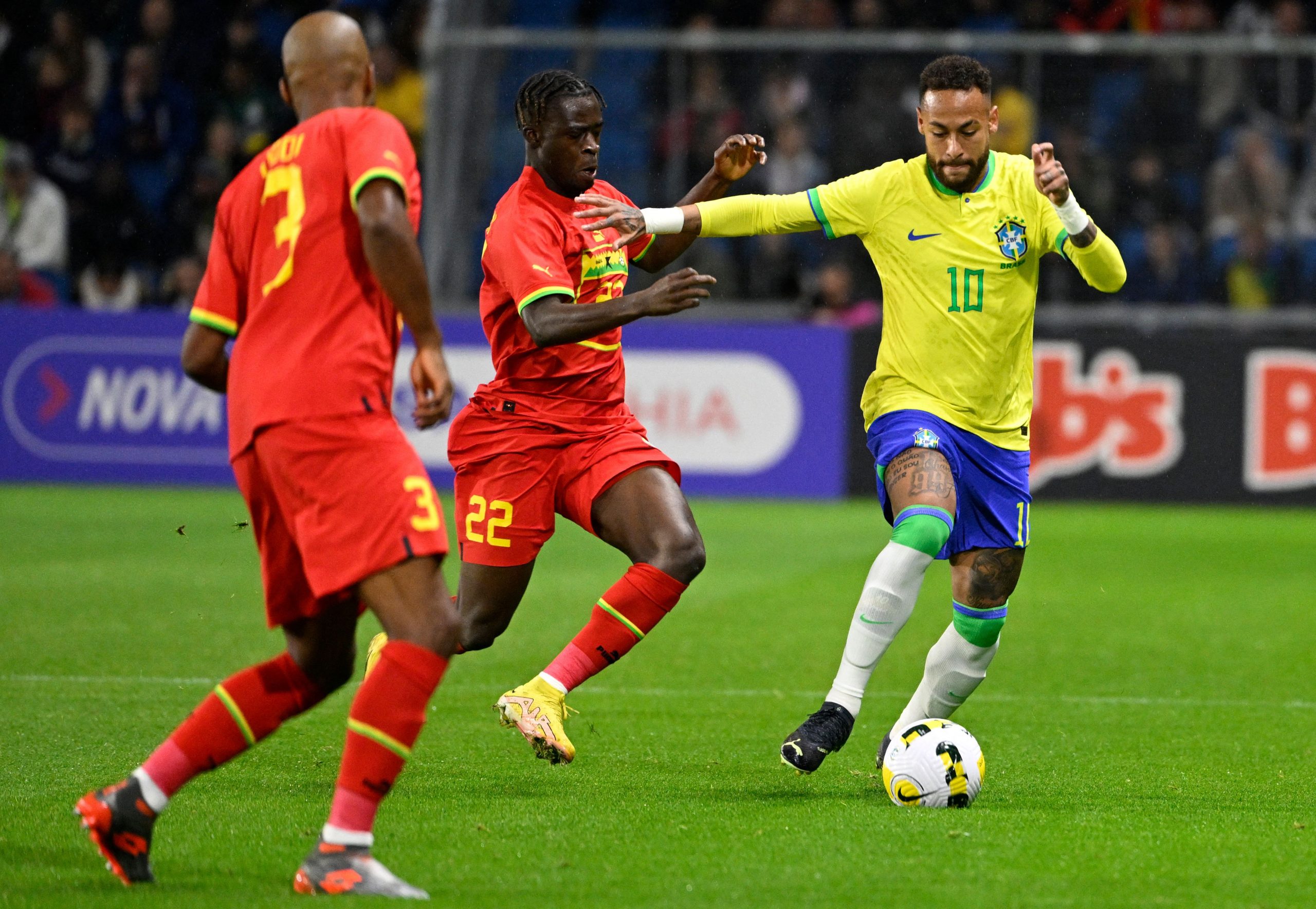 Brazil's Neymar fights for the ball with Ghana's Kamaldeen Sulemana during a friendly.