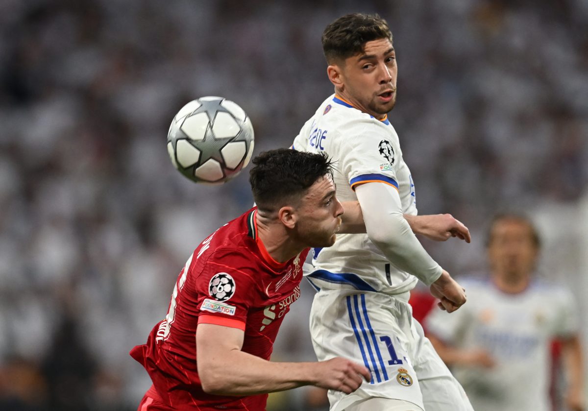 Andy Robertson of Liverpool fights with Real Madrid's Federico Valverde for possession. 