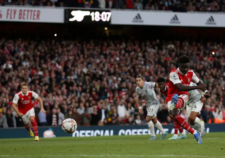 Arsenal's Bukayo Saka scores a penalty kick past Liverpool's Alisson Becker at the Emirates.