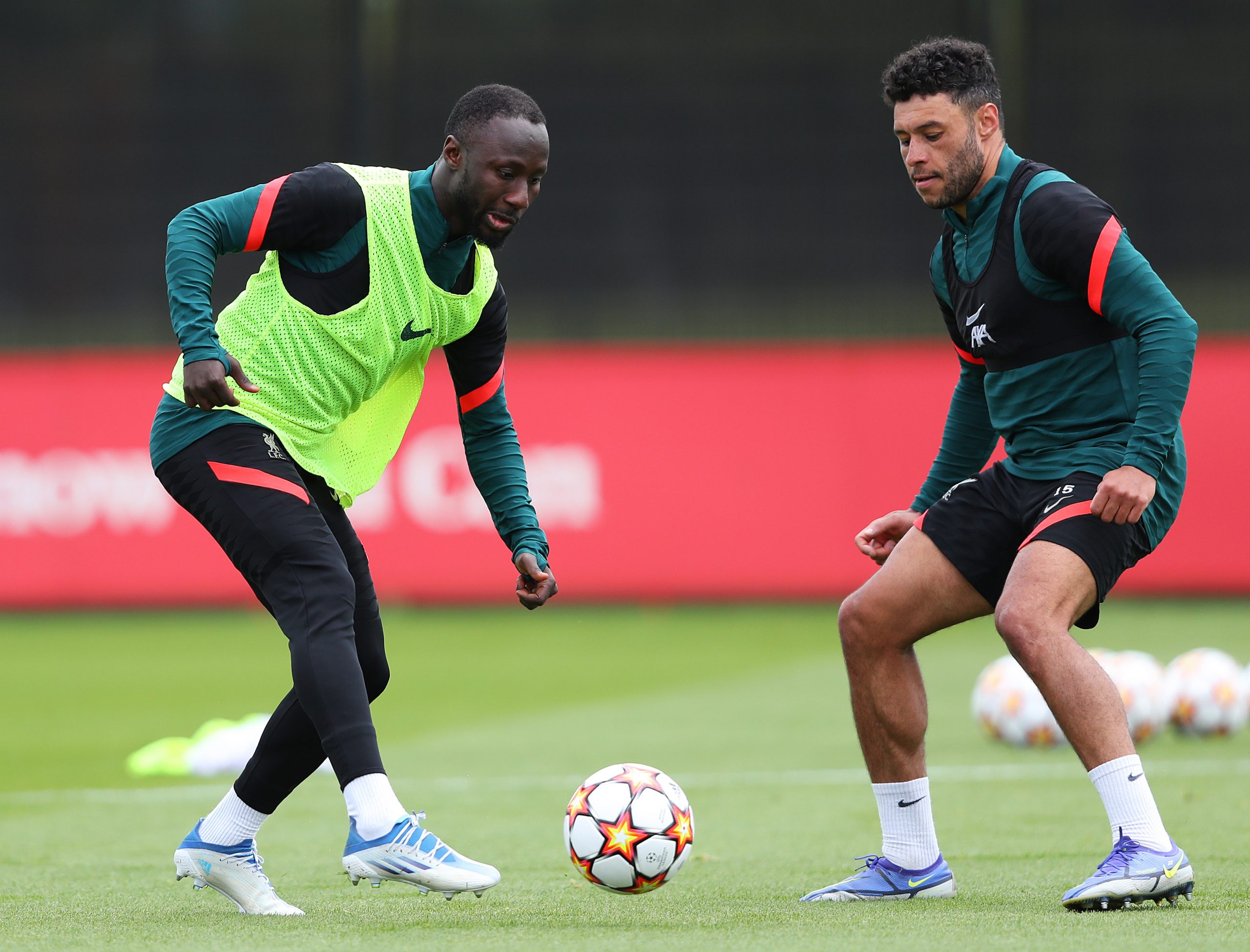 Naby Keita and Alex Oxlade-Chamberlain of Liverpool battle for the ball during a training session.