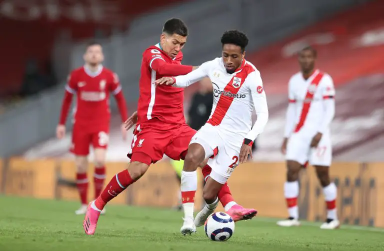 Roberto Firmino of Liverpool battles for possession with Kyle Walker-Peters of Southampton.