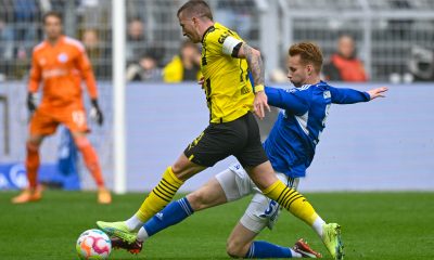 Borussia Dortmund's Marco Reus vies for the ball with Liverpool loanee and Schalke defender, Sepp van den Berg.