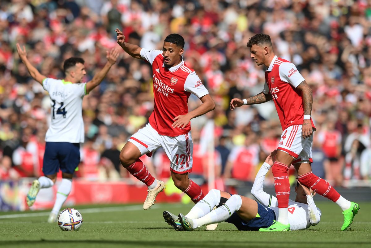 William Saliba of Arsenal avoids a challenge from Son Heung-min of Tottenham Hotspur as Ben White watches on. 