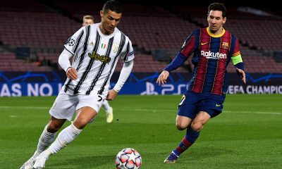 Cristiano Ronaldo of Juventus and Lionel Messi of Barcelona vie for the ball.