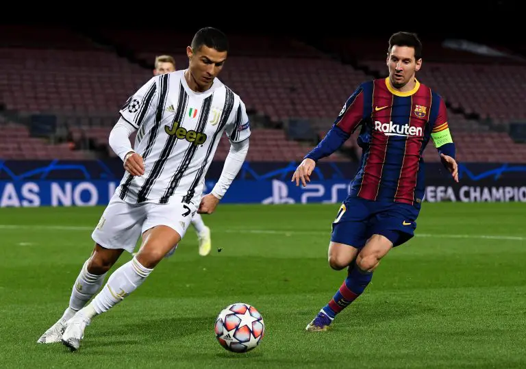 Cristiano Ronaldo of Juventus and Lionel Messi of Barcelona vie for the ball.