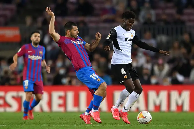 Yunus Musah of Valencia CF is challenged by Sergio Aguero of FC Barcelona. (Photo by David Ramos/Getty Images)