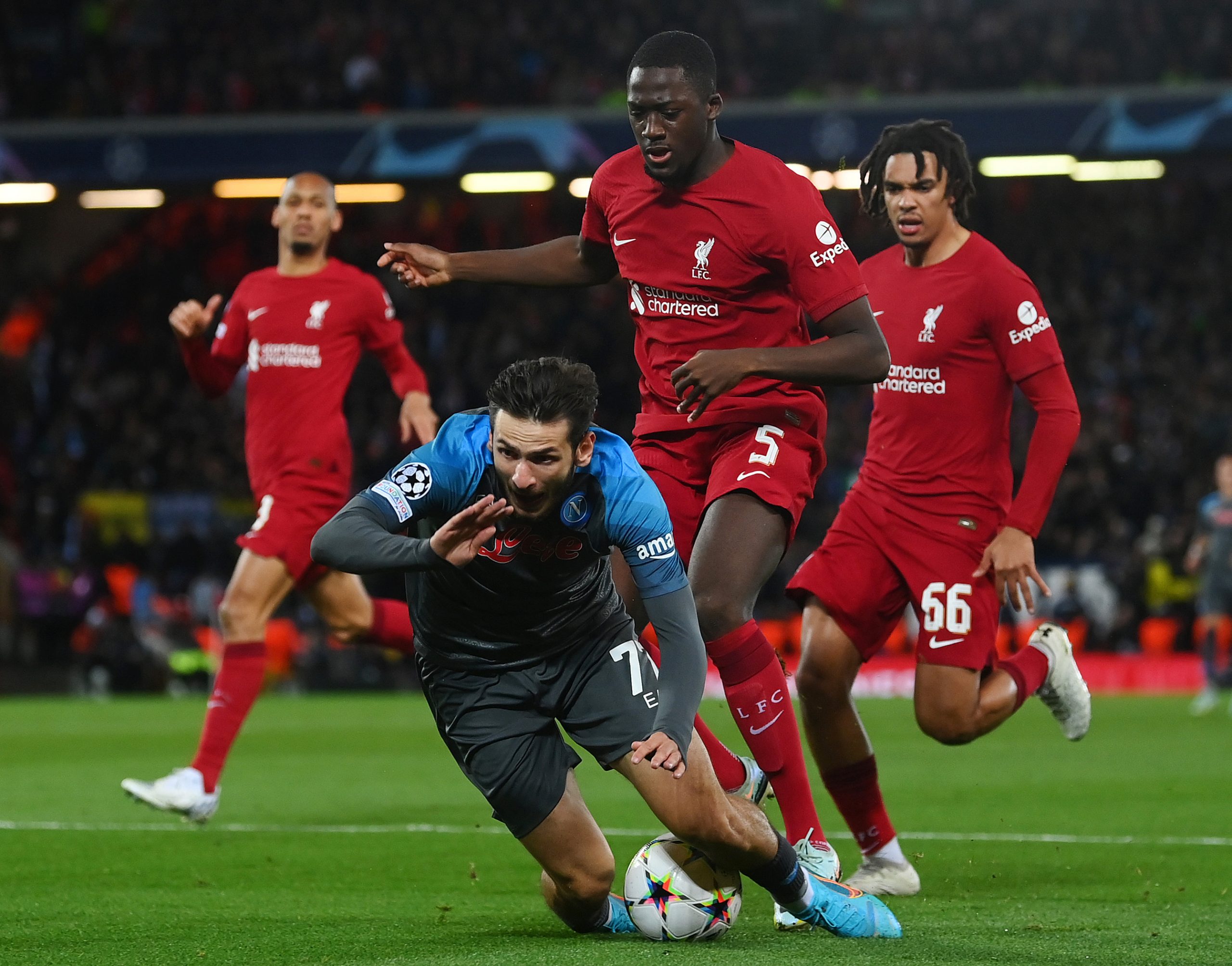 Khvicha Kvaratskhelia of Napoli is challenged by Ibrahima Konate of Liverpool.