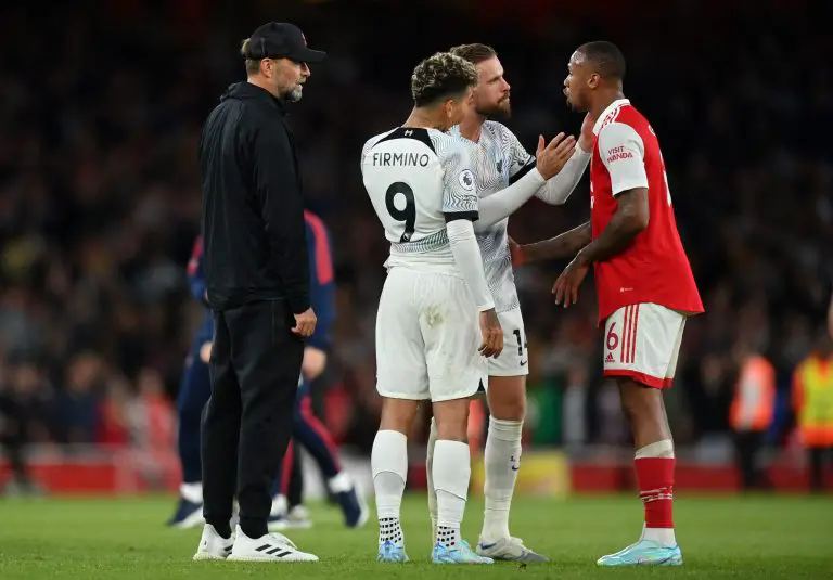 Jordan Henderson of Liverpool speaks with Gabriel of Arsenal as Jurgen Klopp and Roberto Firmino look on.