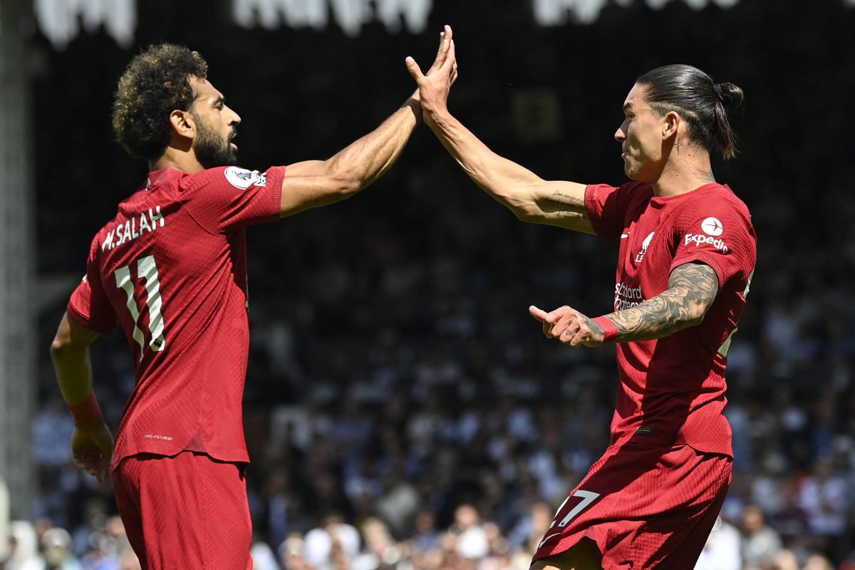 Liverpool's Uruguayan striker Darwin Nunez (R) celebrates with Liverpool's Egyptian striker Mohamed Salah (L) after scoring their first goal during the English Premier League football match between Fulham and Liverpool at Craven Cottage in London on August 6, 2022