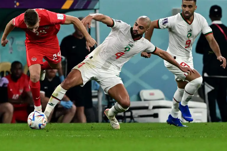 Canada's David Wotherspoon fights for the ball with Morocco's Sofyan Amrabat. (Photo by MIGUEL MEDINA/AFP via Getty Images)