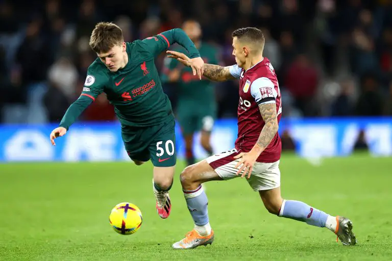 Ben Doak of Liverpool is tackled by Lucas Digne of Aston Villa.