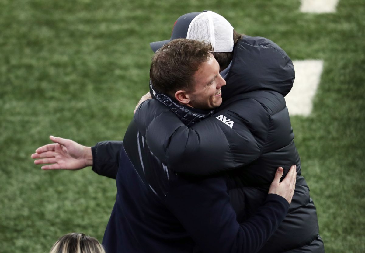 Leipzig's German headcoach Julian Nagelsmann (L) and Liverpool's German manager Jurgen Klopp embrace prior to the UEFA Champions League round of 16 first leg football match between RB Leipzig and FC Liverpool at the Puskas Arena in Budapest on February 16, 2021. (Photo by Ferenc ISZA / AFP) (Photo by FERENC ISZA/AFP via Getty Images)