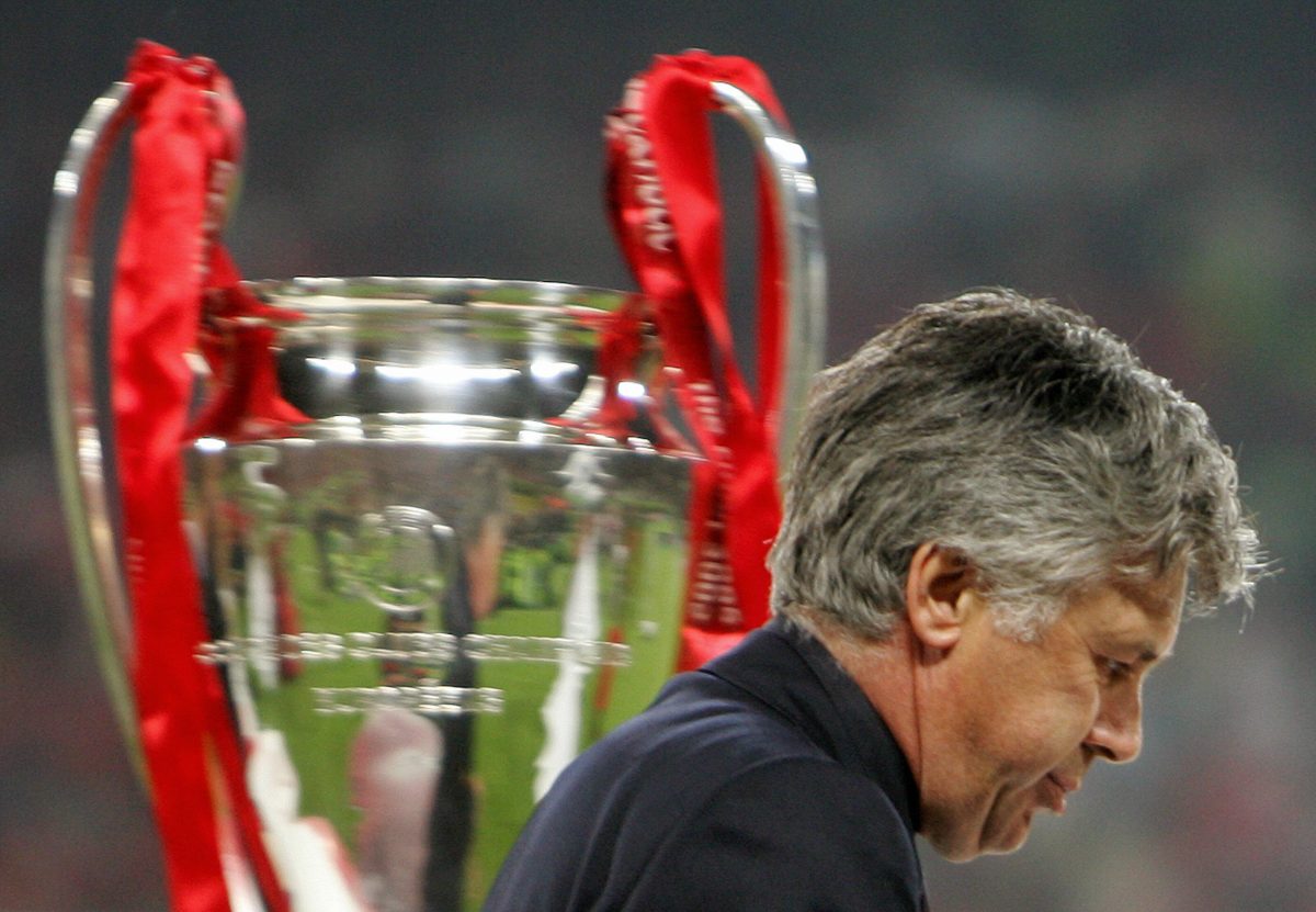 AC Milan's coach Carlo Ancelotti walking by the UCL trophy after Liverpool staged a heroic comeback in the 2005 Champions League final. 